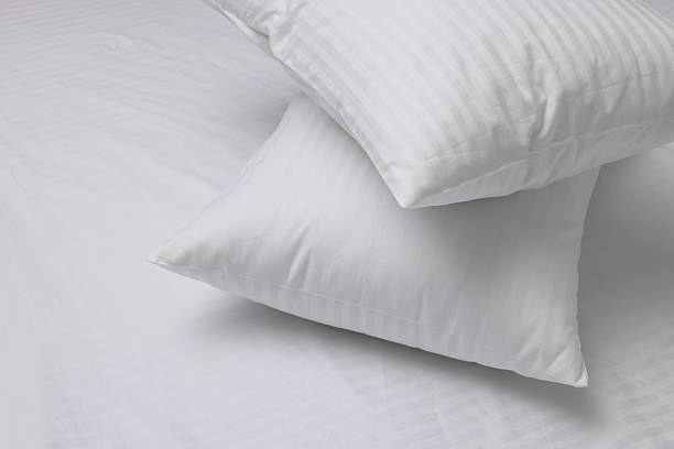istock Bed with white clean linens and pillows 2220762923