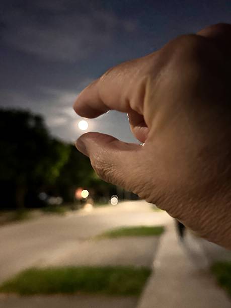 Hand Pinching the Moon at Night