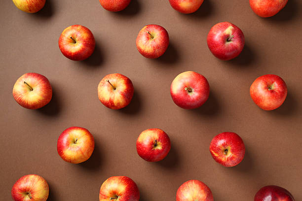 istock Ripe red apples on brown background, flat lay 2220763710