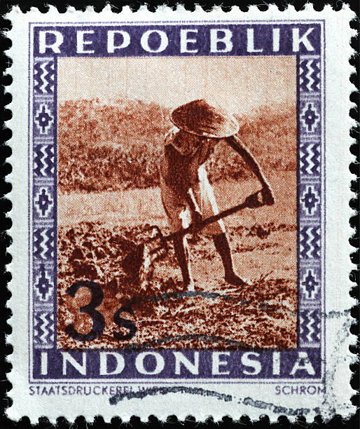istock Farmer at work on old postage stamp from Indonesia 2220764135