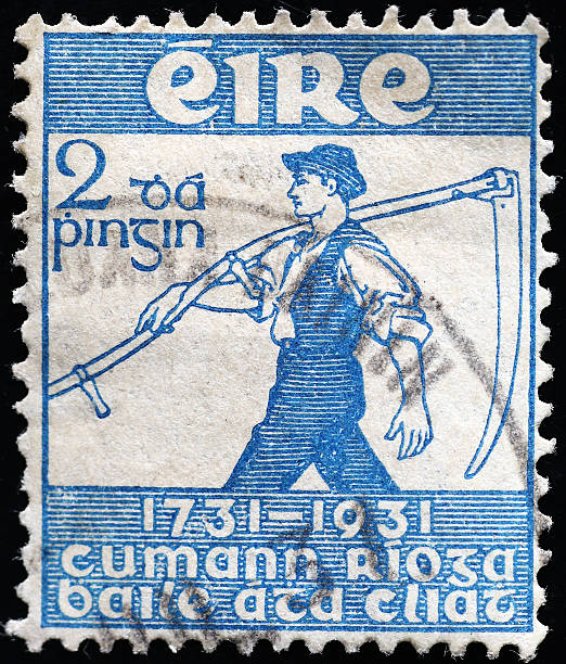 istock Farmer with sickle on vintage irish postage stamp 2220764201