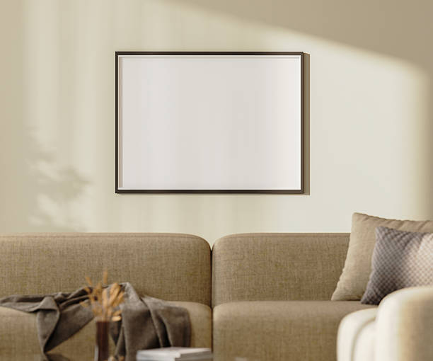 istock blank picture frame mock up on a wall with sunlightith sunlight above brown sofa with pillows and decor, 3d render 2220764287