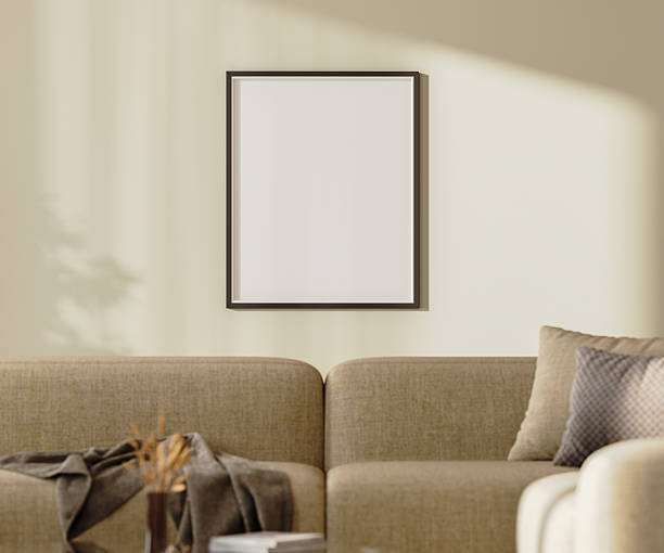 istock blank poster frame mock up on a wall with sunlightith sunlight above brown sofa with pillows and decor, 3d render 2220764309