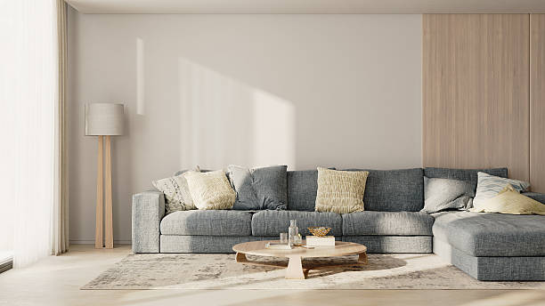istock Living room interior with big blue sofa with pillows, wooden panel, table with decor, floor lamp and rug, 3d render 2220764313