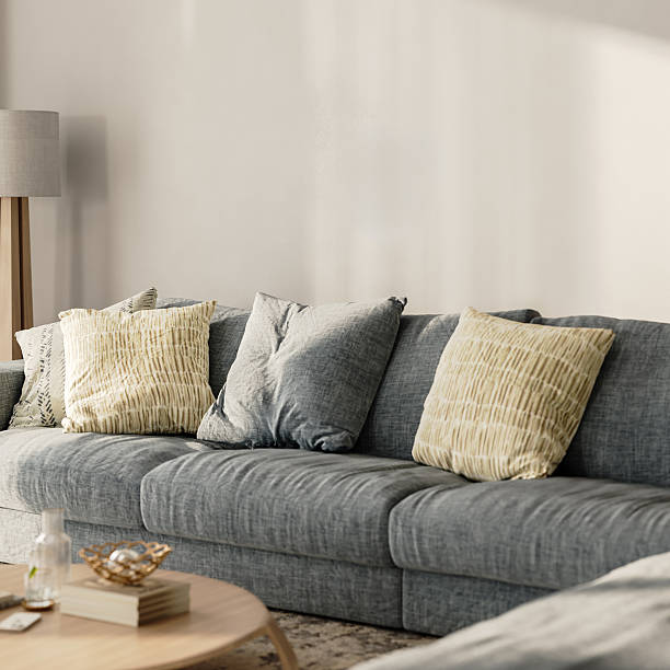 istock Living room interior close-up, blue sofa with pillows, empty wall in the background, 3d render 2220764377