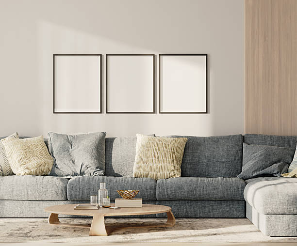 istock Three blank frames in lounge interior with blue sofa and table with wooden panel on the wall, 3d render 2220764389