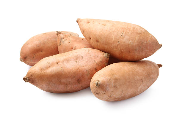 istock Fresh raw sweet potatoes isolated on white 2220765431