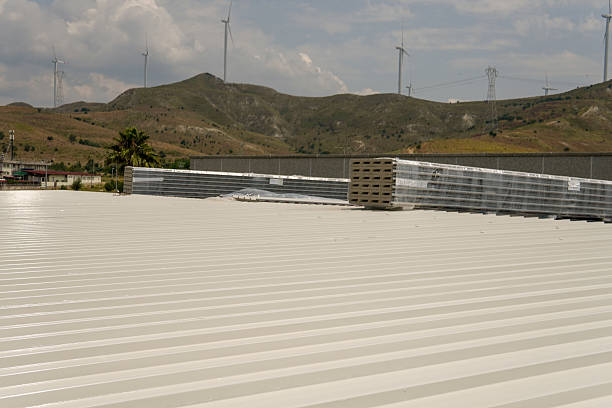 istock Sheet metal roofing on a steel structure under construction. Polyester sandwich panels. This image shows stacks of building materials on a metal roof of an industrial building. 2220765572