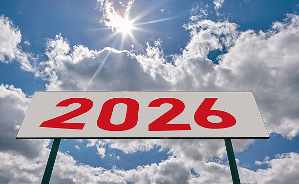 istock Bright sky with clouds and a large sign displaying the year 2026 under the sunlight 2220765924