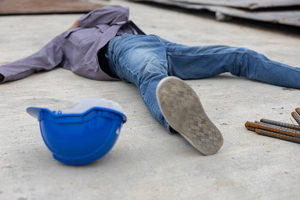 istock Worker lies on construction site floor with safety helmet suffer from accident 2220765960