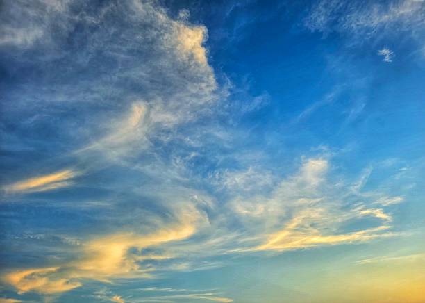 istock Cirrus clouds at dawn in a blue sky 2220772106