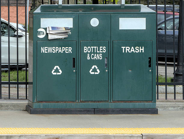 MTA trash can with separate receptacles for newspaper, botles, cans and garbage on the metro north train station platform in Hastings on Hudson, New York.