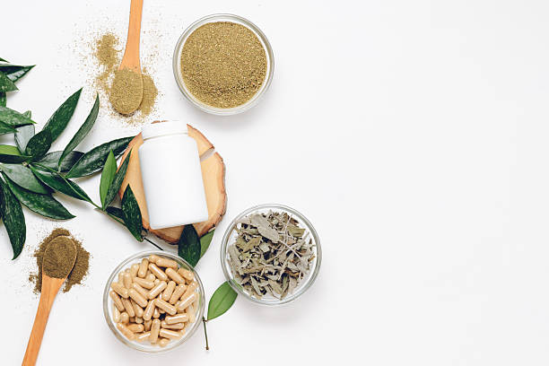 istock Empty medical bottle with herbal pills and dry herbal ingredients 2220774822