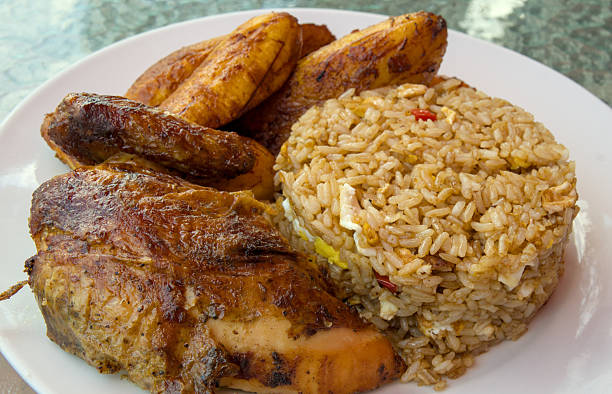 istock peruvian fried chicken dish with pork and egg fried rice fried sweet plantains and spicy green sauce (peru cuisine restaurant special meal ossining new york) white plate rotisserie pollo asian fusion 2220775737