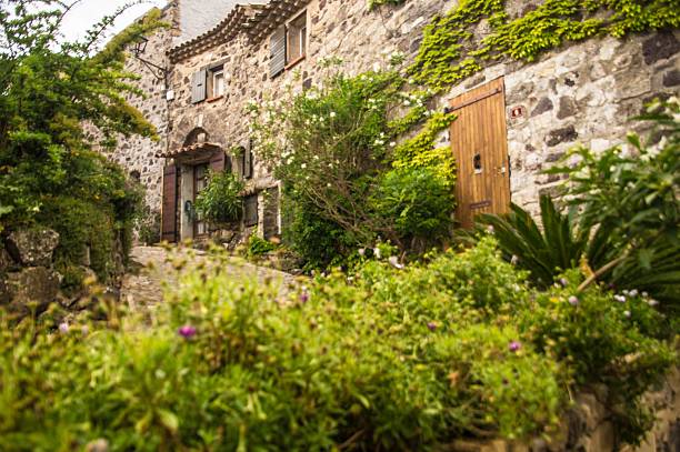 istock Charming stone house with lush greenery in a rustic village. 2220778391