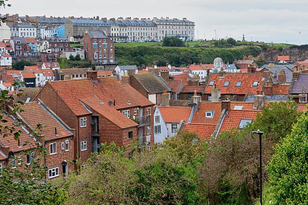istock A view of a town with many red rooftops and a large building 2220778993