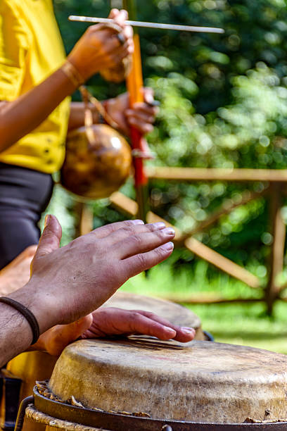 istock Hands of musicians playing berimbau and atabaque 2220780981