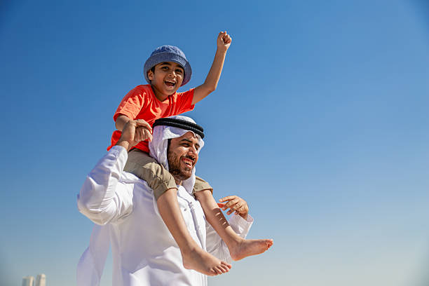 istock Arab father and son having fun at beach 2220781077