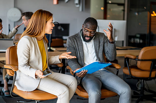 istock Businesspeople having disagreement while reading a document at the office 2220785197