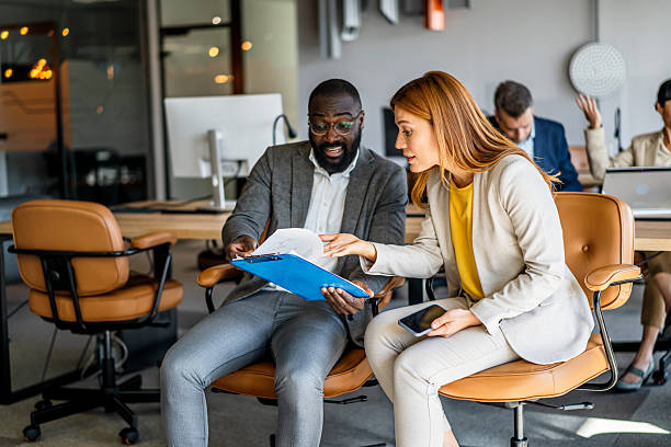 istock Business colleagues reviewing documents in office meeting 2220785674