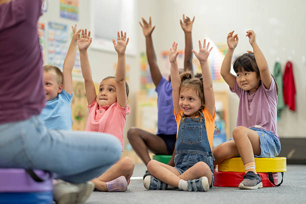 istock Group of Young Children Actively Participating in a Fun Classroom Activity 2220789518