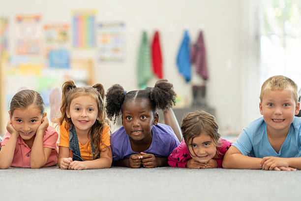 istock Happy Group of Diverse Children Smiling Together in a Classroom Setting 2220789891