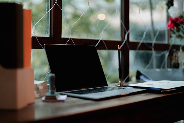 istock Minimal Office Workspace by the Window with Laptop and Files.3 2220790092