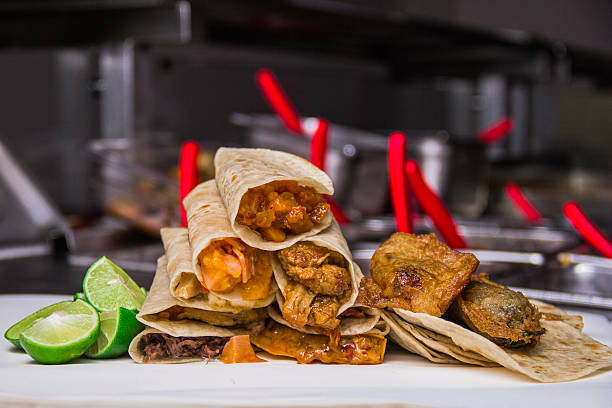 istock A mouthwatering selection of assorted tacos with lime wedges elegantly arranged on a white plate, highlighting the vibrant colors and freshness of the ingredients. 2220791609