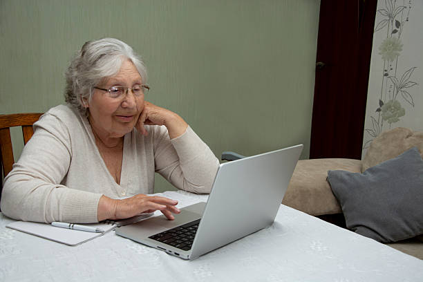 istock Senior woman using laptop at home 2220791691