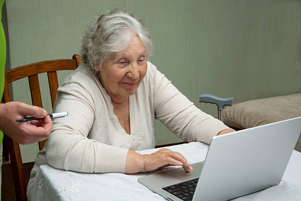 istock Senior woman using laptop at home 2220791709