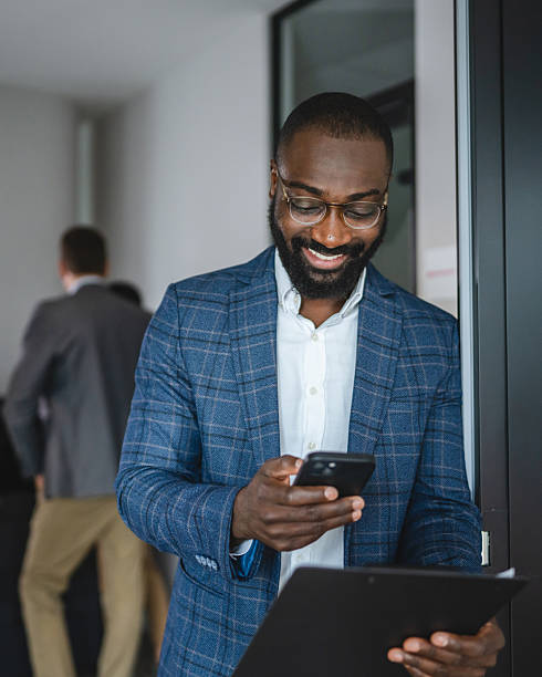 istock black businessman use cellphone to scan document on clipboard 2220794696