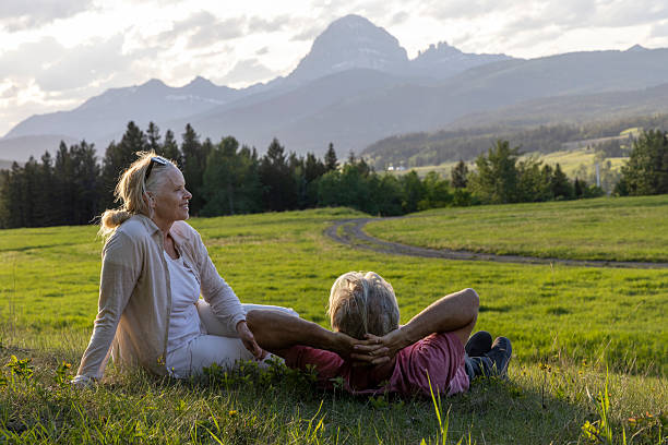 istock Mature couple pause in mountain meadow at sunset 2220794797