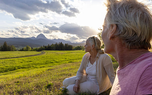 istock Mature couple pause in mountain meadow at sunset 2220794881