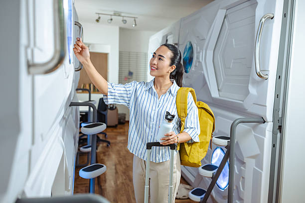 istock Woman exploring innovative sleeping pods with a yellow backpack 2220795122