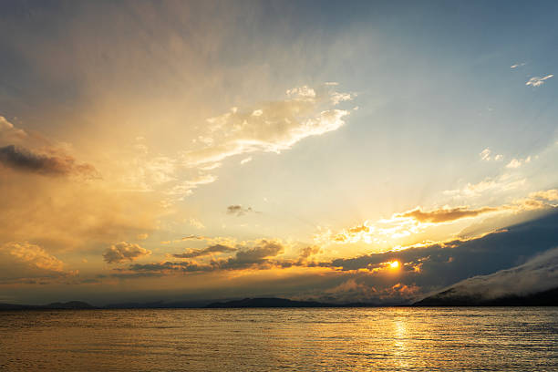 Beautiful sunset with clouds over the lake.
