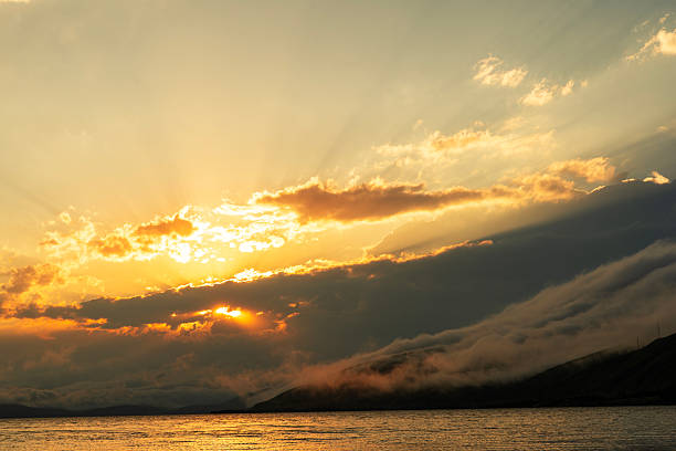 Beautiful sunset with clouds over the lake.