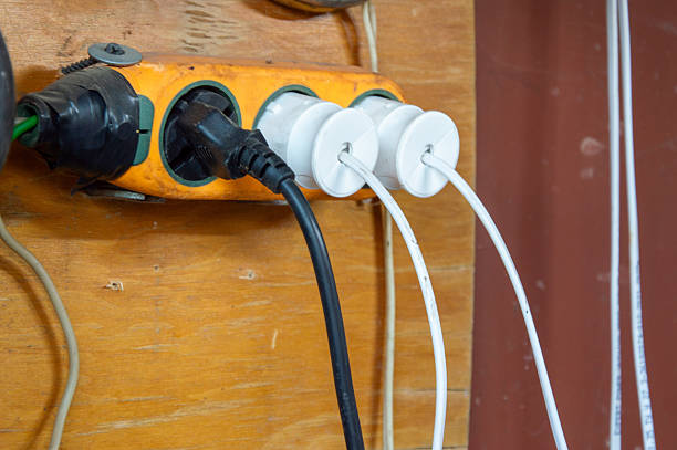 istock A power strip mounted on a wall connects several electric cords for various devices in a workspace setting, emphasizing organization 2220796844