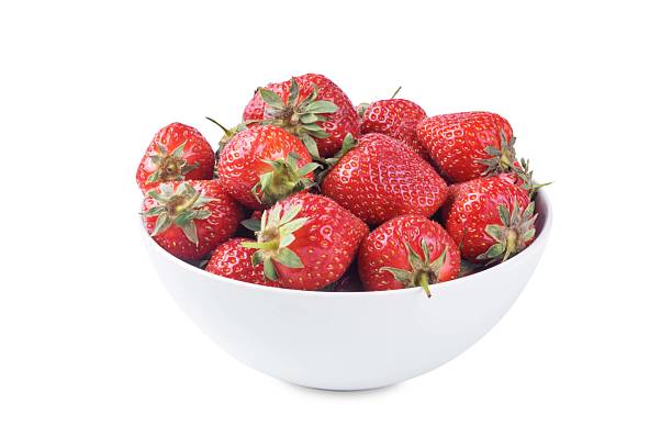 istock Fresh red strawberries in a white bowl on a white isolated background 2220798826