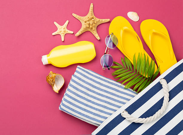 istock Blue beach bag with summer accessories on color background, top view 2220800515
