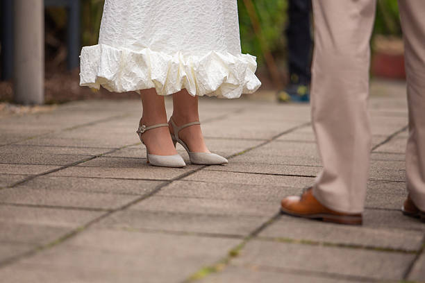 istock Legs of bride and bridegroom 2220801318