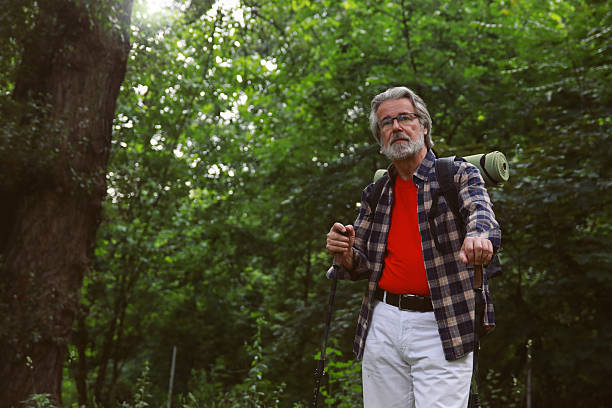 istock Hiking senior man in nature forest active life 2220801346