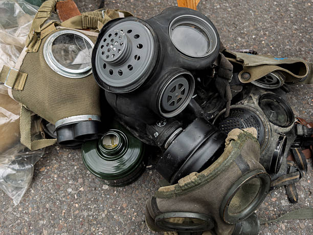 istock Assorted Military Gas Masks Piled on Ground 2220801790