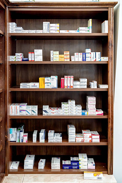 istock Wooden shelf filled with medication boxes in a pharmacy environment 2220801839