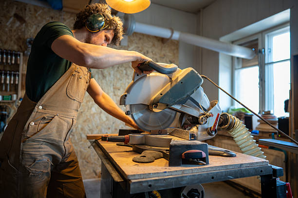 istock Eperienced woodworker use mitre saw, slice wood blocks for project. Craftsmanship, blade control 2220802291
