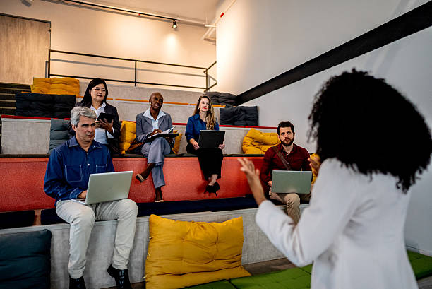 istock Coworkers using laptop during presentation in office auditorium 2220803924