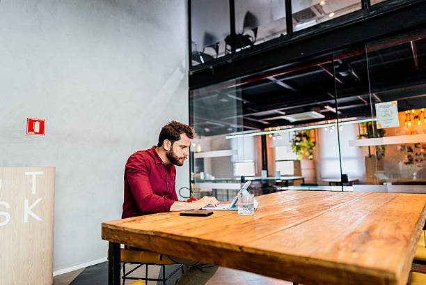 istock Mid adult businessman using digital tablet on the office 2220807296