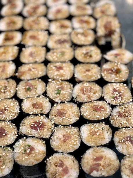 istock Variety of Freshly Prepared Sushi Rolls Beautifully Arranged on Display for Patrons. Exquisite and vibrant array of sushi rolls brilliantly showcasing various ingredients with artistic presentation 2220808021