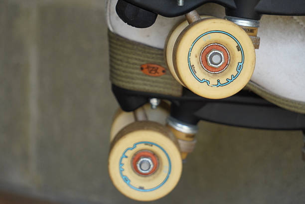 A close-up shot captures the worn wheels of a roller skate, revealing the intricate details of their bearings and the faint outlines of their original markings, hinting at countless journeys and adventures.