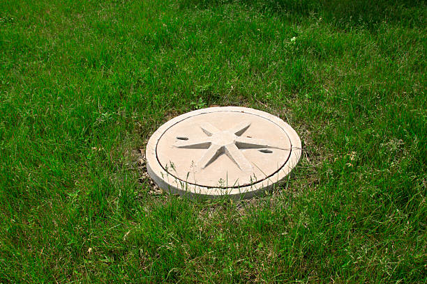 Cement covers in the lawn, closeup of photo