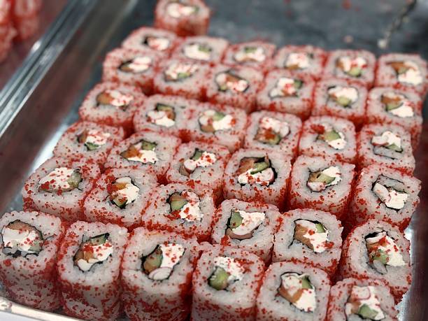 istock Indulge in these utterly Delicious Sushi Rolls beautifully Garnished with Bright Red Tobiko. Vibrant array of sushi rolls topped with red tobiko, perfect for food enthusiasts and cuisine photography 2220809031